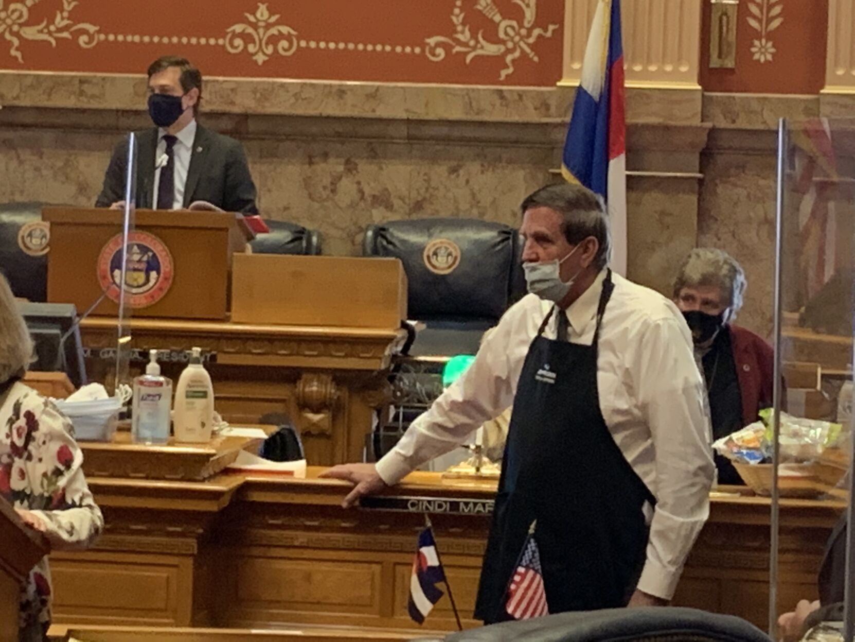 Sen. John Cooke in chef's apron